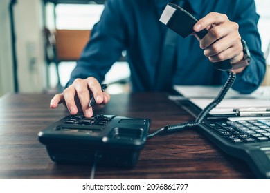 businessman dialing desk phone in the office. Telephone dialing ,contact and customer service. - Shutterstock ID 2096861797