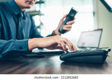 businessman dialing desk phone in the office. Telephone dialing ,contact and customer service.