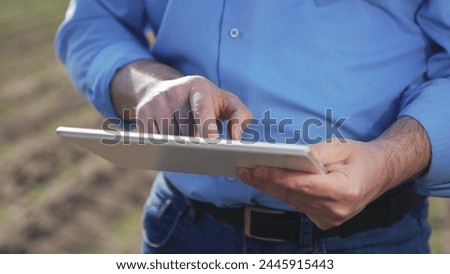 Businessman digital agricultural farmer with tablet. Hands male professional using tablet. Creation planting plans harvest schedules labor allocation aspects of agricultural business farm management.
