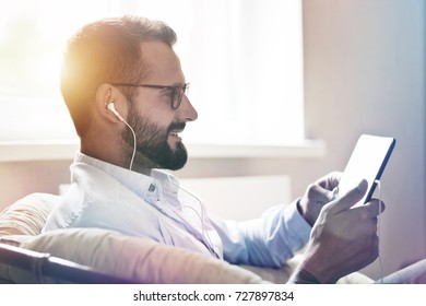 businessman with digital tablet and earphones - Powered by Shutterstock