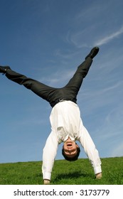 Businessman Doing Cartwheel Outdoors