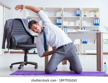 Businessman doing sports at his office space - Powered by Shutterstock