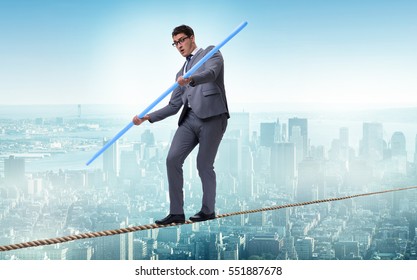 Businessman Doing Tightrope Walking In Risk Concept