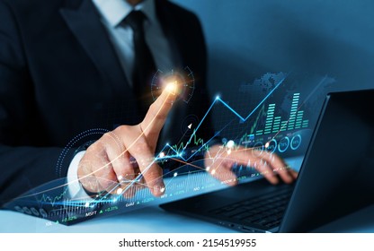Businessman draw growing virtual hologram of statistics, graph and chart.Business strategy development and growing growth plan. Investment of growth on currency rate.