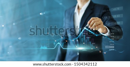 Businessman draw growth graph and progress of business and analyzing financial and investment data ,business planning and strategy on blue background.