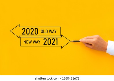 Businessman drawing arrow panel with Old way 2020 and New way of the  year 2021. Improvement and change management.