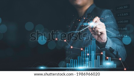 Businessman drawing virtual technical graph and chart for analysis stock market, technology investment and value investment concept.