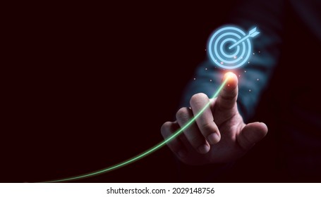 Businessman drawing and writing virtual trend to target for setup business plan and objective target concept.  - Shutterstock ID 2029148756