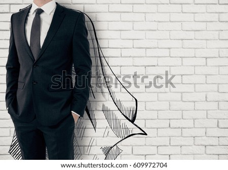 Businessman with drawn cape on white brick background. Leadership concept