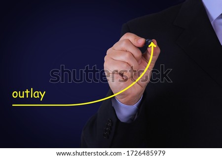 Businessman draws an arrow with the text OUTLAY symbolizing take-off. Business concept.