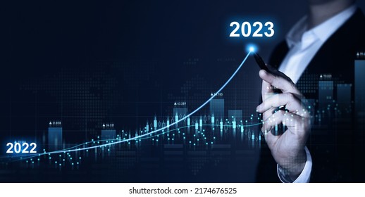 Businessman draws increase arrow graph corporate future growth year 2022 to 2023. Planning,opportunity, challenge and business strategy. New Goals, Plans and Visions for Next Year 2023. - Shutterstock ID 2174676525