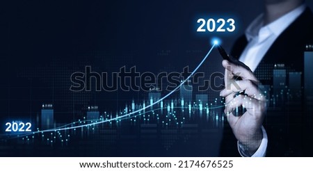 Businessman draws increase arrow graph corporate future growth year 2022 to 2023. Planning,opportunity, challenge and business strategy. New Goals, Plans and Visions for Next Year 2023.