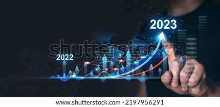 Businessman draws increase arrow graph corporate future growth year 2022 to 2023. Planning,opportunity, challenge and business strategy. 