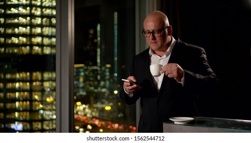 Businessman Drinks Coffee Holds Phone In Office Slow Motion