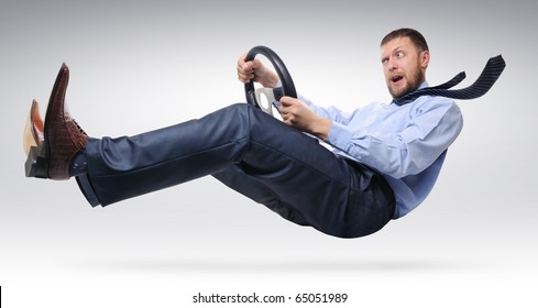 Businessman driver with open mouth in a tie with a wheel concept