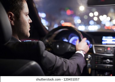 Businessman Driving A Car At Night
