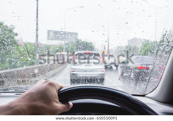 Businessman driving\
private cars to work on rainy roads and traffic jams. business\
concept in rush\
hour.