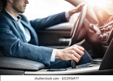 Businessman driving a sportive luxury car