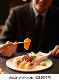 Businessman Eating Salmon Sashimi Japanese Style