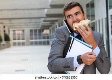 Businessman eating a sandwich on the go