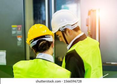 Businessman or engineers are training new employees In industrial plants that have machines and injection molds. The concept of welcoming new employees, teaching, training - Shutterstock ID 1566596728