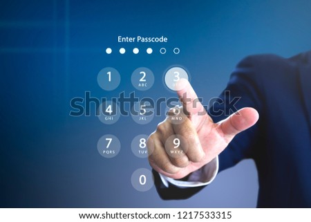 Businessman entering security passcode on a virtual login keypad screen to login to an encrypted computerised database system personal account