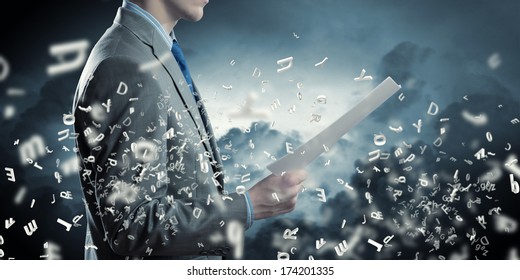 Businessman examining document in hands. Signing contract