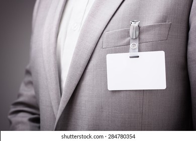 Businessman at an exhibition or conference wearing a blank security identity name card or tag
