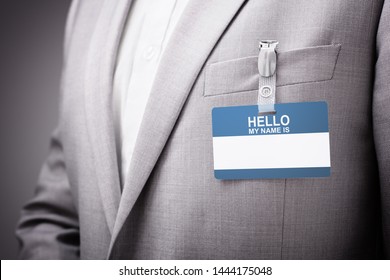 Businessman At An Exhibition Or Conference Wearing A Hello My Name Is Security Identity Name Card Or Tag