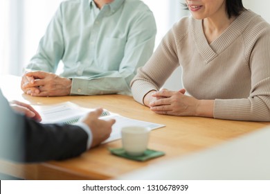 A businessman explaining to a middle-aged couple