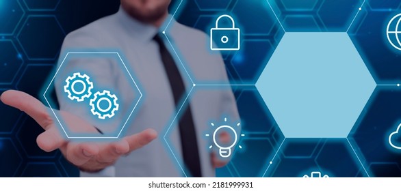 Businessman Extending Hand And Showing Digital Symbols And Settings In An Abstract Hexagon Pattern. Man With Necktie Presenting Innovation And Important Information.