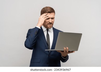 Businessman failed on stock exchange from decline in quotations, unsuccessful transaction. Tired upset sad trader man of problem in business, poor financial results looks at laptop on gray background - Powered by Shutterstock