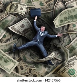 Businessman Falling Into Tunnel Of $100 Dollar Bills