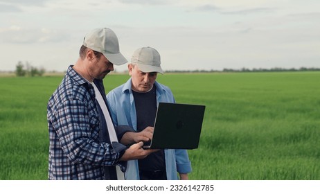 businessman farmer working field with laptop. partnership work. business partners talking about deal. agricultural industry farmer, digital computer, business transaction, conversation farmer field - Powered by Shutterstock