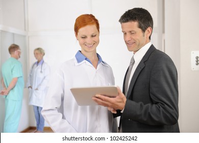Businessman with Female Doctor at the Hospital