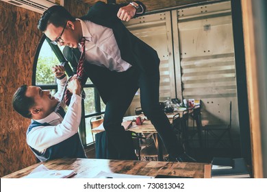 Businessman Fighting With His Coworker In Office.