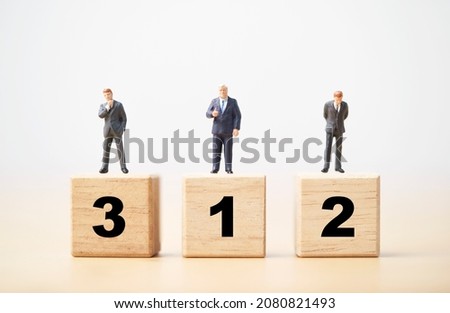 Businessman figure standing on wooden podium number 1 2 and 3 for business ranking competition concept.