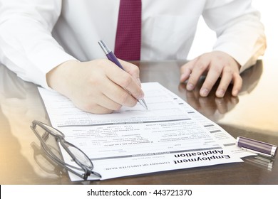 Businessman fill in Employment Application form concept with a pen or job vacancy.