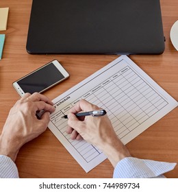 Businessman Filling Timesheet