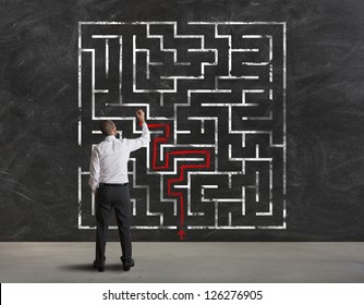 Businessman Finding The Solution Of A Maze