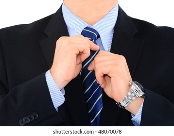 Businessman is fixing his necktie isolated over white
