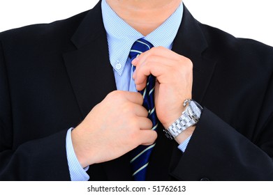 Businessman is fixing his necktie isolated over white