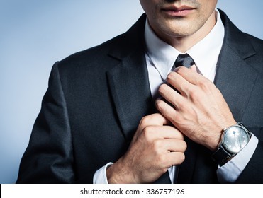 Businessman Fixing His Tie. 