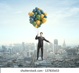 businessman flying with air balloons over the city - Powered by Shutterstock