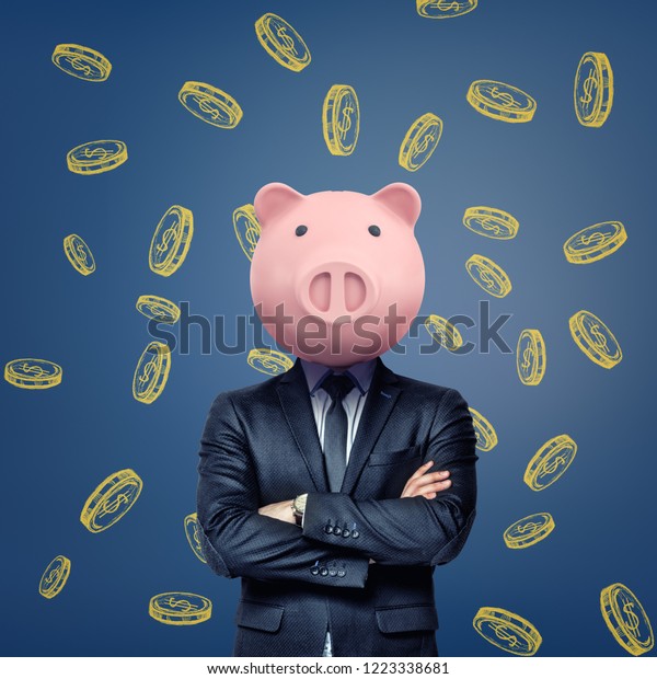 A businessman\
with folded arms stands wearing a pink pig mask on a background\
with chalk golden coins. Business and banking. Thinking to get\
rich. Money saving and\
investing.
