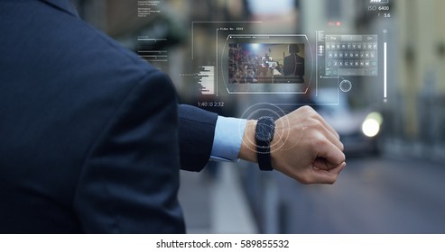 A businessman is followed by a conference on the economy and finance that appears in hologram clock futuristic and technological. Concept: network, conference, technology, augmented reality and future