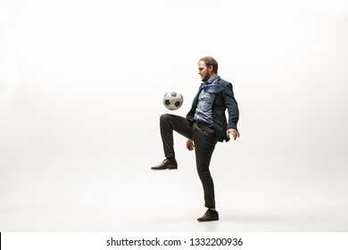 Businessman With Football Ball In Office. Soccer Freestyle. Concept Of Balance And Agility In Business. Manager Perfoming Tricks Isolated On White Studio Background.