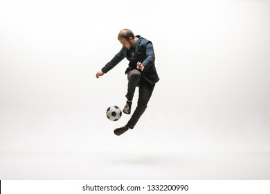 Businessman With Football Ball In Office. Soccer Freestyle. Concept Of Balance And Agility In Business. Manager Perfoming Tricks Isolated On White Studio Background.