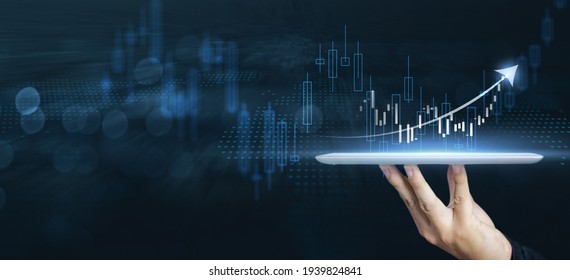 Businessman forex trader using tablet technology indicating rising trend growth in the market, analyzing financial data buying stock exchange currency, crypto forex stock market blue banner background - Shutterstock ID 1939824841