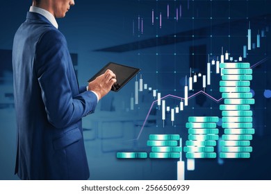 Businessman in formal attire using tablet, with financial graphs, bar charts on blue background, concept of finance, investing